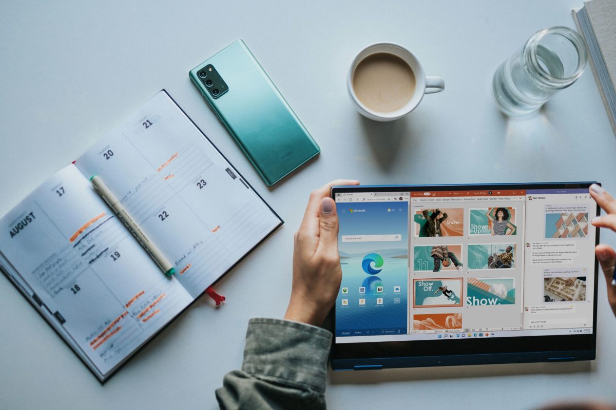 10-Tips-To-Get-The-Most-Out-Of-Your-Microsoft-365-Apps-scaled.jpg person using Windows 11 computer beside white ceramic mug on white table
