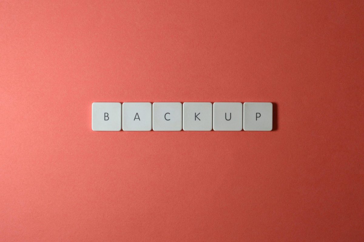 Simple-Backup-and-Recovery-Plans-Every-Small-Business-Needs-scaled.jpg Free Close-up of keyboard keys spelling 'BACKUP' placed on a coral-colored surface. Stock Photo